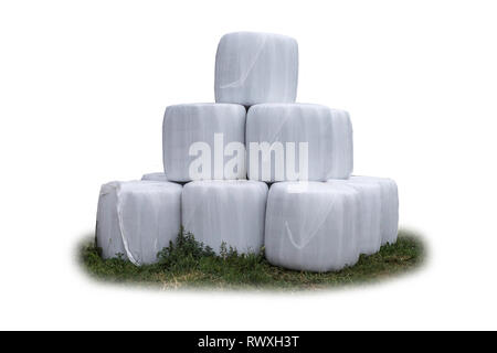 Stacked like a pyramid,bales of silage , wrapped in a membrane. Food  for the cows in the winter on a dairy farm. General view.  Isolated photo . Stock Photo