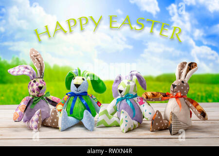 Easter bunnies family with happy easter inscription. Easter holiday concept. Stock Photo