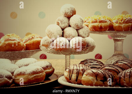 Sweet donuts on rustic wooden table, close up vintage view Stock Photo