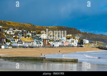 Lyme Regis, Dorset, UK. 7th April 2026. UK Weather. A sunbather on the ...