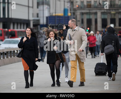 London, UK. 7th Mar, 2019. UK Weather: People struggle to walk against the blustery winds over London Bridge in London. Credit: Keith Larby/Alamy Live News Stock Photo