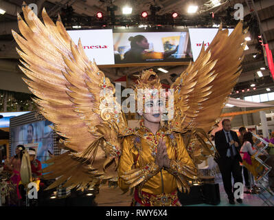 Berlin, Germany. 07th Mar, 2019. A dancer in a golden costume with wings at the stand of Indonesia Credit: Soeren Stache/dpa/Alamy Live News Stock Photo