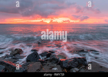 Mousehole, Cornwall, UK. 8th March 2019. UK Weather.  There was a fiery sunrise at Mousehole this morning, with a brief shower of rain before the sun came up. Credit: Simon Maycock/Alamy Live News Stock Photo