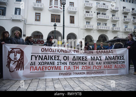 Thessaloniki, Greece. 8th Mar, 2019. Women hold a banner during a protest. Due to International Women's Day women of the Hellenic Women Federation demonstrated at the center of the city, demanding equal rights with men in the labor sector and improvement on the working conditions of working mothers. Credit: Giannis Papanikos/ZUMA Wire/Alamy Live News Stock Photo