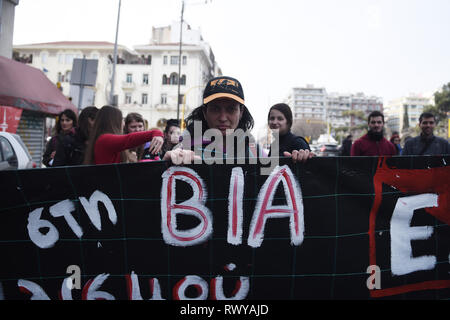 Thessaloniki, Greece. 8th Mar, 2019. A woman holds a banner as she marches during a protest. Women working at the public sector demonstrated at the center of the city due to the International Women's Day, demanding equal rights with men in the labor sector and improvement on the working conditions of working mothers. Credit: Giannis Papanikos/ZUMA Wire/Alamy Live News Stock Photo