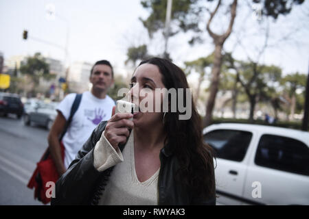 Thessaloniki, Greece. 8th Mar, 2019. A woman chants slogans as she marches during a protest. Women working at the public sector demonstrated at the center of the city due to the International Women's Day, demanding equal rights with men in the labor sector and improvement on the working conditions of working mothers. Credit: Giannis Papanikos/ZUMA Wire/Alamy Live News Stock Photo