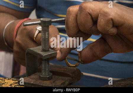 (190308) -- KOLKATA, March 8, 2019 (Xinhua) -- A worker makes gold jewellery at a workshop in Kolkata, India, March 8, 2019. Indian jewellery industry plays an important role in the economy, accounting for 7 percent of GDP and 14 percent of merchandise exports and provides direct employment to 5 million people. (Xinhua/Tumpa Mondal) Stock Photo