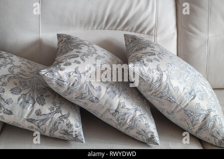 several patterned pillow on the light sofa Stock Photo