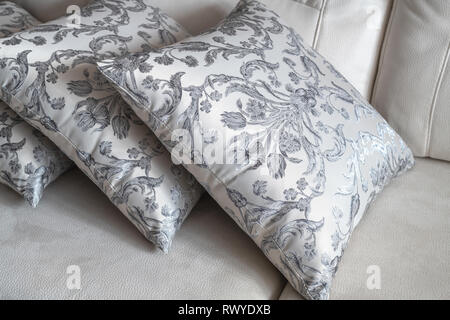 several patterned pillow on the light sofa Stock Photo