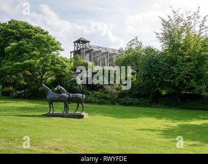 Sculpture of horses (Pferde) by Philipp Harth and graduation tower in the Gruga Park in Essen, Germany Stock Photo