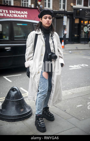 LONDON - FEBRUARY 15, 2019: Stylish attendees gathering outside 180 The Strand for London Fashion Week. Stock Photo