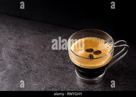 coffee glass and coffee grain on black background. Copyspace Stock Photo