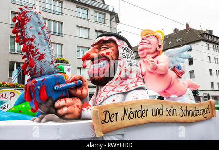 Düsseldorf, Germany. 4 March 2019. The annual Rosenmontag (Rose Monday or Shrove Monday) carnival parade takes place in Düsseldorf. Donald Trump watching over Mohammed bin Salman, crown prince of Saudi Arabia, who is wielding a chain saw. Carnival float designed by German artist Jacques Tilly. Stock Photo