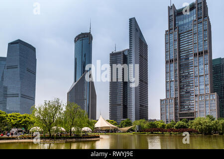 Bocom Financial Towers, Bank of China Tower and the Bank of Shanghai provide an impressive backdrop to the serenity of Lujiazui Park. Shanghai, China. Stock Photo