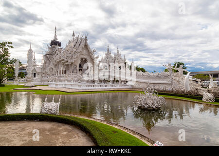 Temple highly visited by tourists in Chiang Rai, Wat Rong Khun, perhaps best known to Foreigners as the White Temple, is a contemporary, unconventiona Stock Photo