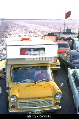 Purpose made RV camper van motorhome built 1970s on yellow Ford Transit chassis loaded on Scottish Highlands car ferry family touring holiday 1974 UK Stock Photo