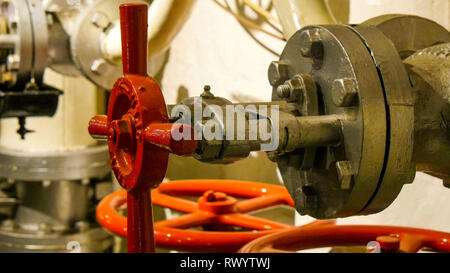 Red hydraulic round equipment for gas and water pumping. Stock Photo