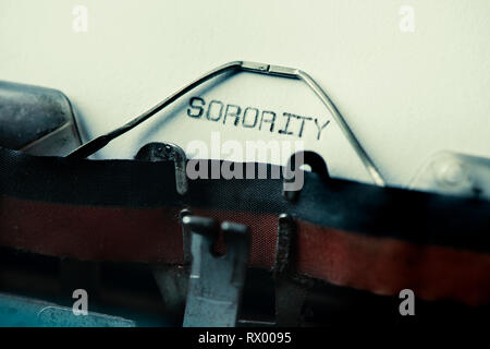 closeup of the text sorority written with an old typewriter on a yellowish paper Stock Photo
