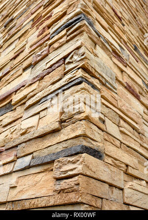 Corner of hew stone walls. Cut stone rustication texture. Stock Photo