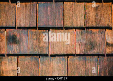 Old wood shingles wall. Wooden shingles texture. Stock Photo