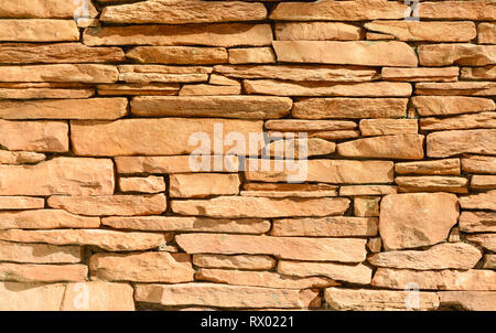 Sand colored stone setting. Stone wall texture. Stock Photo