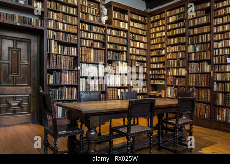 Very old library, 16th Century bookshelves with old fashioned light ...