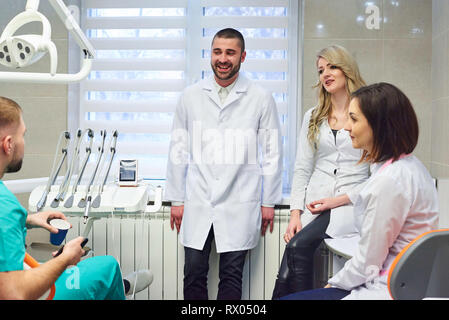 Young caucasian dentists on coffee break. Smiling and talking Stock Photo