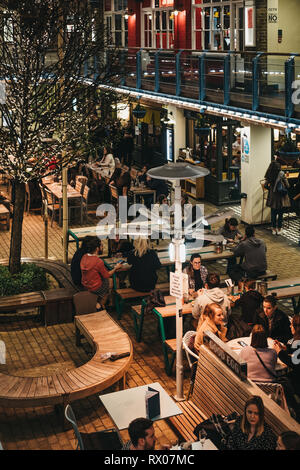 London, UK - March 6, 2019: People sitting at the outdoor tables of Kingly Court, a three-storey alfresco food and dining courtyard in the heart of Lo Stock Photo