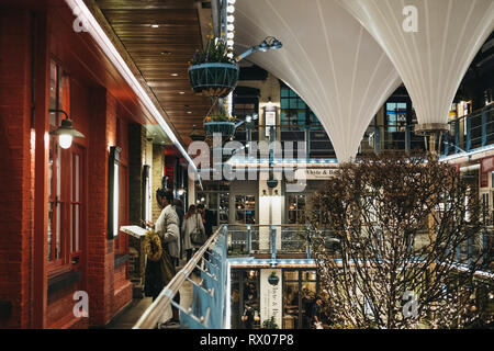 London, UK - March 6, 2019: People inside Kingly Court, a three-storey alfresco food and dining courtyard in the heart of London’s West End. Stock Photo