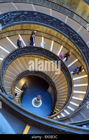 Tourists Descending Double helix Spiral Staircase, or Bramante Staircase, designed by Giuseppo Momo in 1932, Pio-Clementine Museum, Vatican Museums Stock Photo