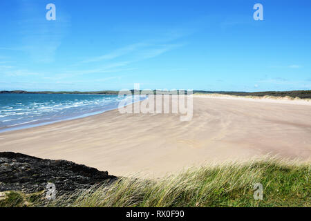 The beautiful and remote sandy beach on the northern side of Llanddwyn Island, which is set on the beautiful Isle of Anglesey in North Wales. Stock Photo