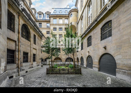 The garden courtyard in the former prison which held Marie Antoinette, the Conciergerie, in Paris, France Stock Photo