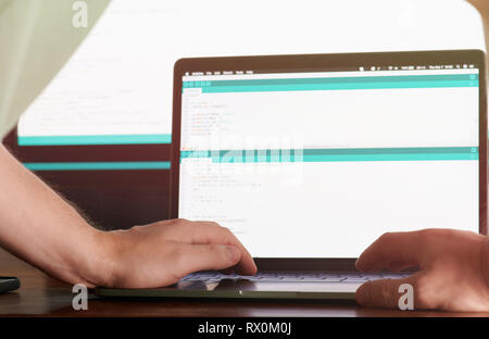 Woking on web application code. Man working as programmer Stock Photo
