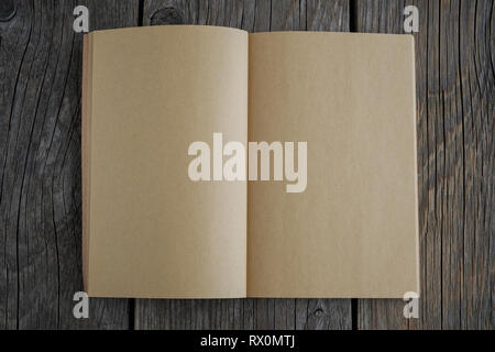 Open old empty book on wooden board. Stock Photo