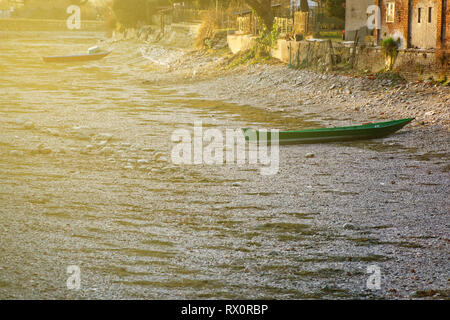 River drought, green boat without water due global warming. Stock Photo