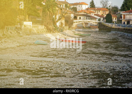 River drought, red boat without water due global warming. Stock Photo