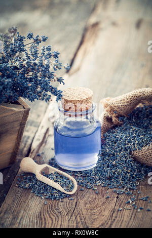 Lavender essential oil or infusion, hessian bag of dry lavender dried flowers. Stock Photo