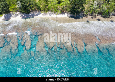 Aerial view of reef and island in Papua New Guinea. The remote, tropical islands in this region are home to extraordinary marine biodiversity. Stock Photo