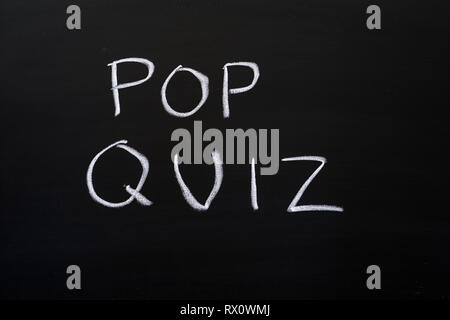 pop quiz written on a blackboard with white chalk Stock Photo