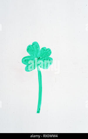 green four leaf clover drawing on a whiteboard with green dry erase marker with copyspace Stock Photo