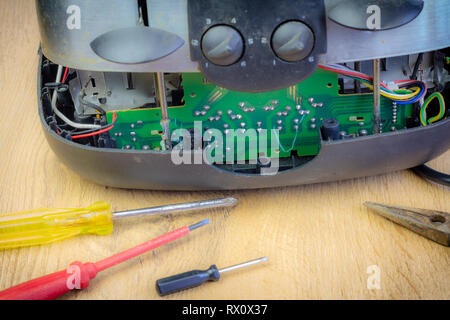 Concept Right to Repair, image showing consumer repairing toaster with tools. Reduce waste by repairing household appliances. Stock Photo