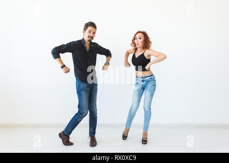 Social dance concept - Crazy dancing, cheerful couple over white background Stock Photo