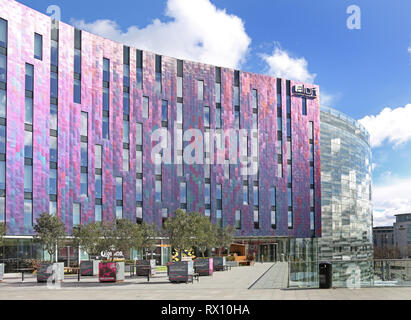 The new 'W' Aloft hotel next to the Excel Exhibition Centre in London's docklands district, east of the City. Shows multi-coloured metallic cladding. Stock Photo