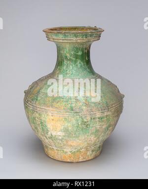 Han Dynasty Pottery Jar with Green Glaze and Molded Masks as Applied Handles Han Dynasty Pottery Jar with Green Glaze and Molded Masks as Applied Handles
