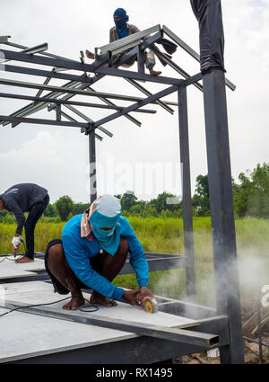 Workers cutting materials with a cutting machine in countryside construction site Stock Photo