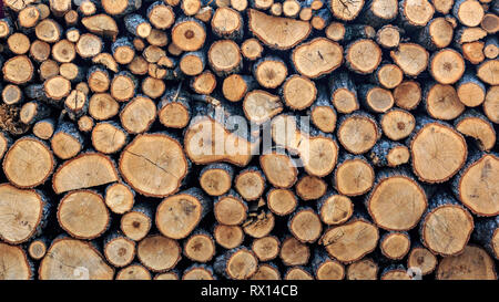 Background of firewood harvested for the winter season for heating a home or bath and sauna Stock Photo