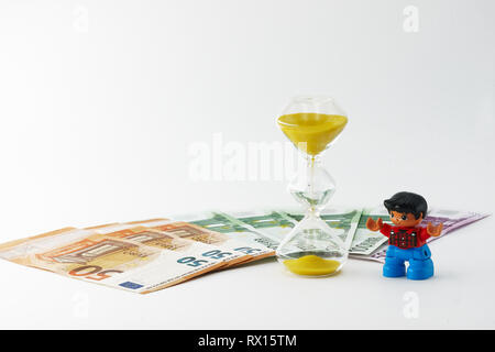 Lego figures, money and hourglass - omini lego, banconote e clessidra Stock  Photo - Alamy