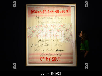 Embargoed to 2300 Friday March 8 A visitor looks at Drunk to the Bottom of My Soul by Tracey Emin, during a photo call for The George Michael Collection art sale at Christie's, London. Stock Photo