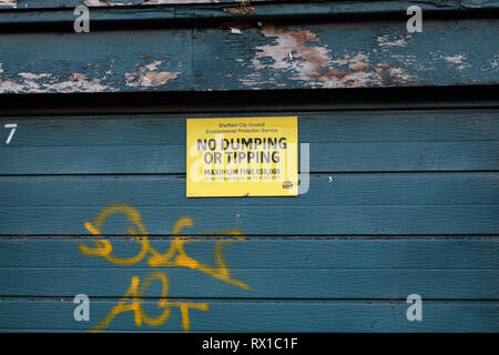 No dumping or tipping sign on garage door Stock Photo
