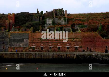 Remains of the buildings that housed the hoppers and crusher above Porthgain harbour, Pembrokeshire, UK. Stock Photo